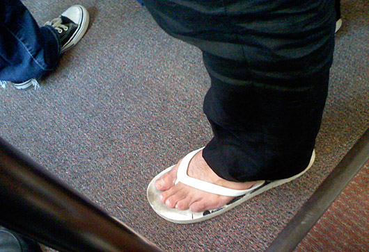 white flip flops on the subway